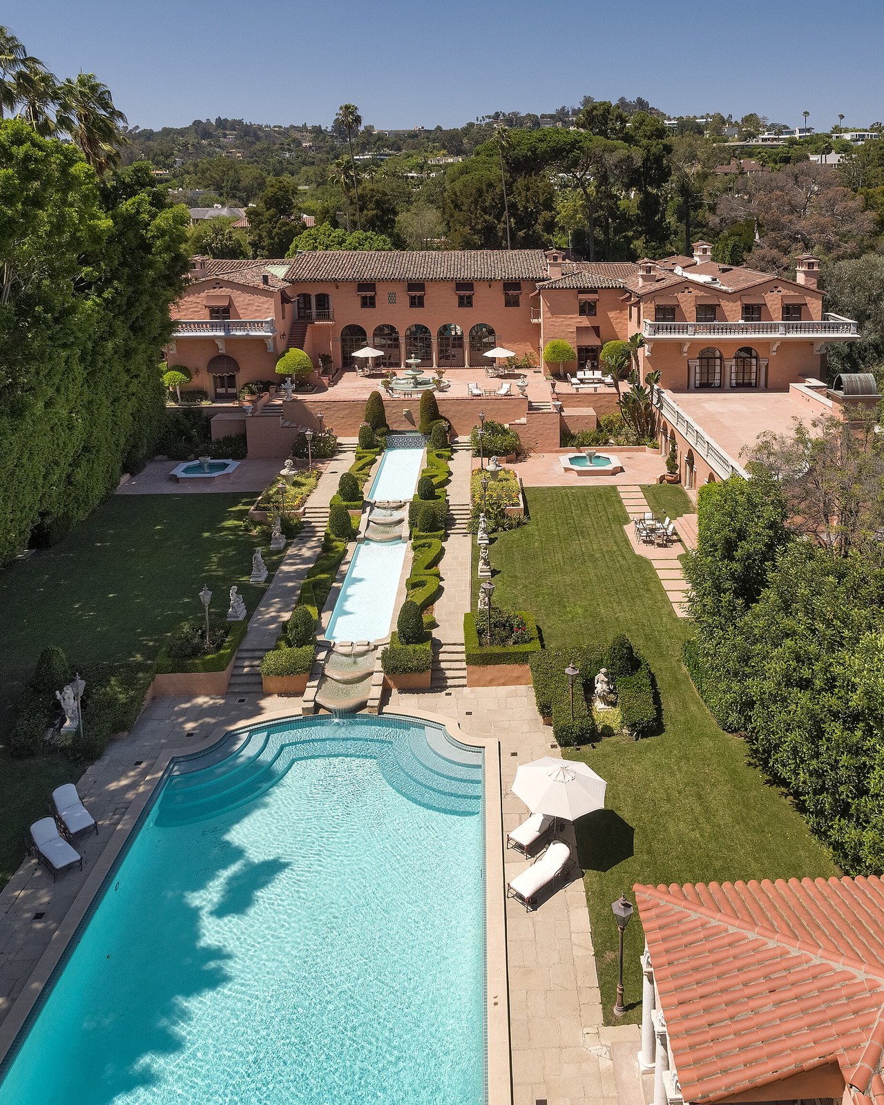 A Beverly Hills estate with terraced lawns, water features and a pool, seen from above; illustrative property, not a Yelena Mun listing